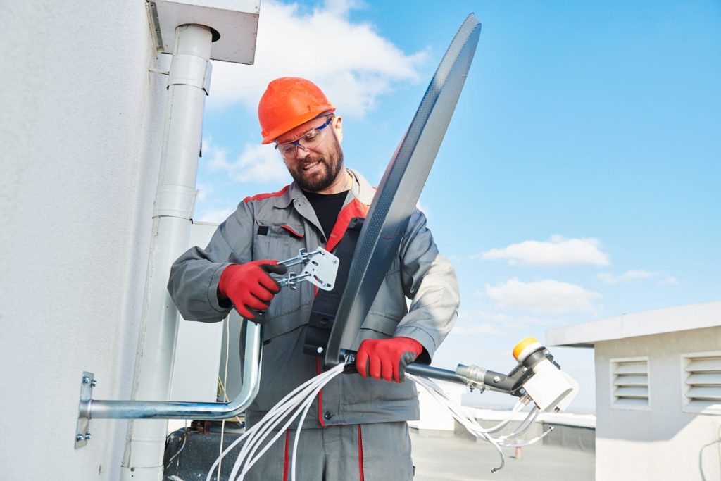 Man working with satellite dish